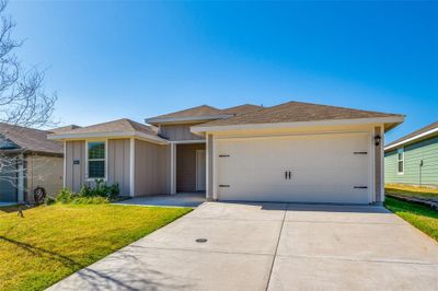 View of front facade with a front lawn and a garage | Image 3