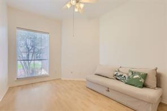 Living area with a ceiling fan and wood finished floors | Image 25