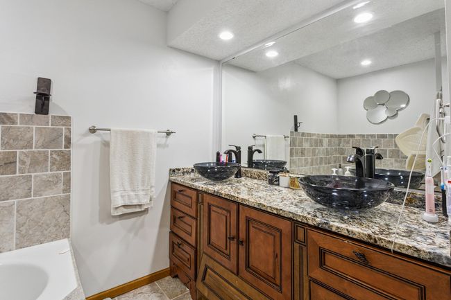 Primary bathroom with dual vanity, separate jacuzzi tub and shower. | Image 11