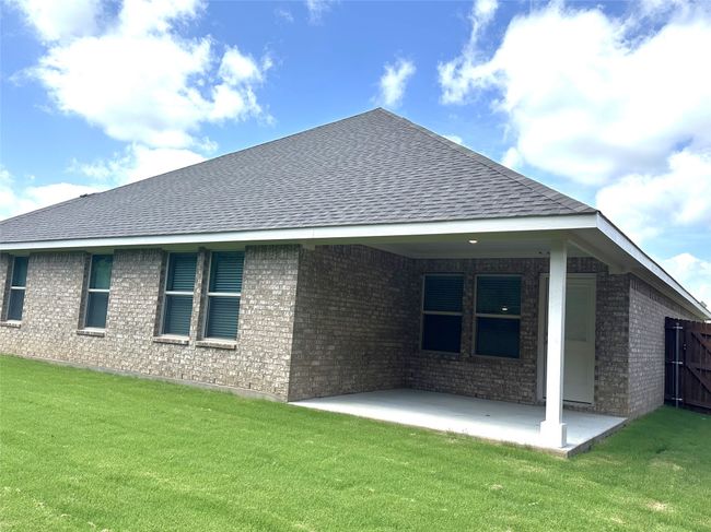 Back of property with roof with shingles, brick siding, a lawn, and a patio | Image 23