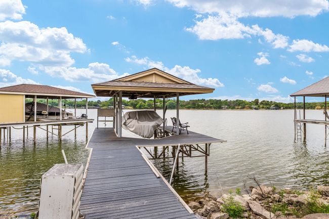 Dock area featuring a water view and boat lift | Image 38