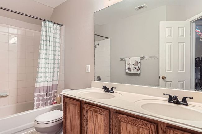 Full bathroom with double vanity and shower / bath combo with shower curtain | Image 22