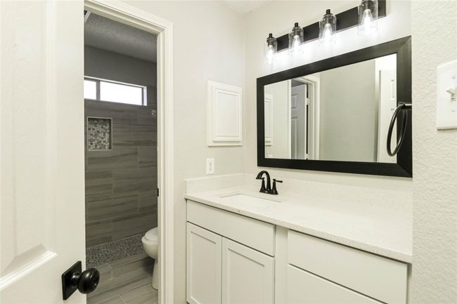 Full bathroom featuring vanity, a stall shower, and toilet | Image 14