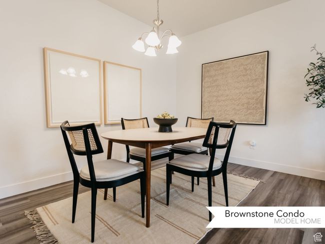 Dining space featuring baseboards, wood finished floors, and a notable chandelier | Image 8