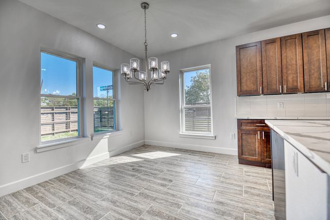 Unfurnished dining area with a wealth of natural light and an inviting chandelier | Image 31