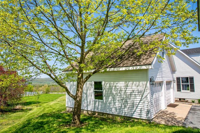 View of side of home featuring a garage and a yard | Image 34