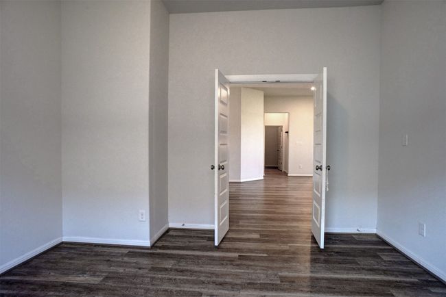 Unfurnished room with dark wood finished floors and baseboards | Image 18