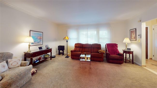 Living area featuring crown molding and carpet floors | Image 5