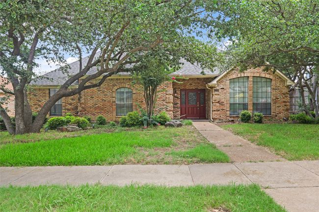 View of front of house featuring brick siding, a front lawn, and roof with shingles | Image 6