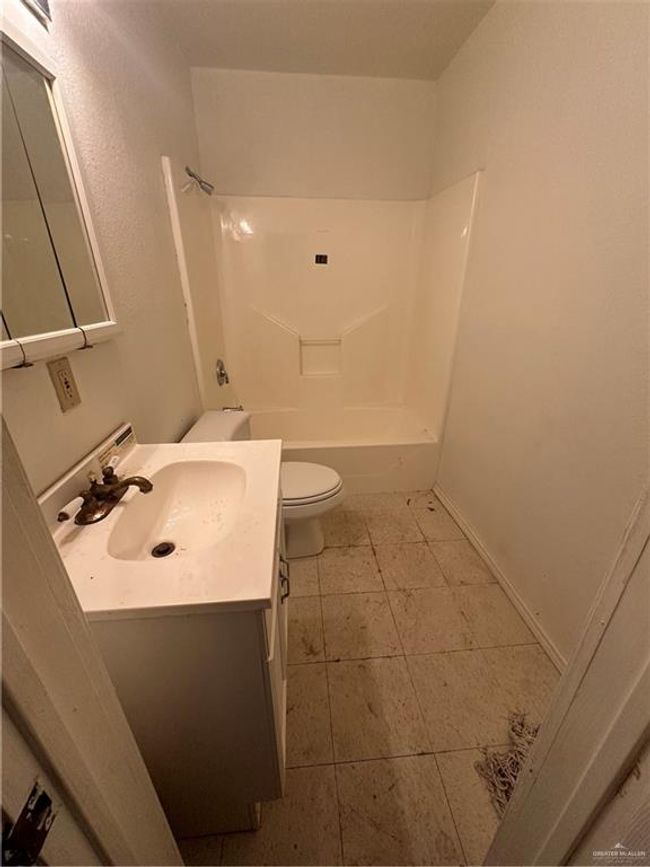Full bathroom with tile patterned flooring, vanity, toilet, and shower / bathtub combination | Image 15
