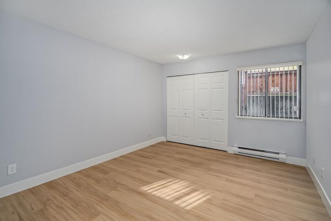 Unfurnished bedroom featuring a baseboard radiator, baseboards, and light wood finished floors | Image 11