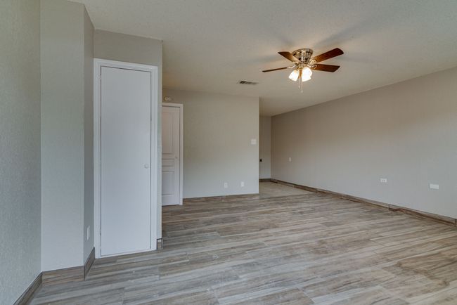 Unfurnished room featuring light wood-type flooring, visible vents, a ceiling fan, and baseboards | Image 5