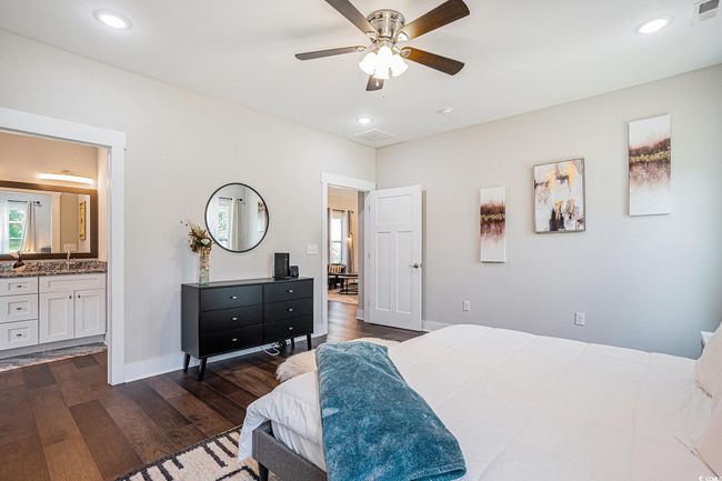 Bedroom featuring dark wood-style flooring, ensuite bathroom, recessed lighting, and a ceiling fan | Image 12
