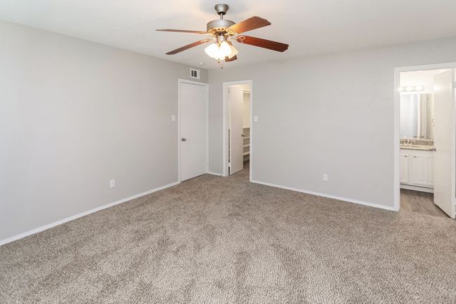 Empty room with ceiling fan and carpet | Image 18