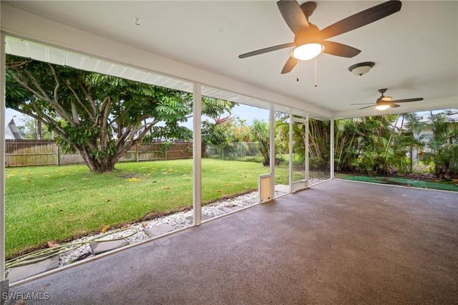 Fenced backyard featuring ceiling fan and a patio | Image 26