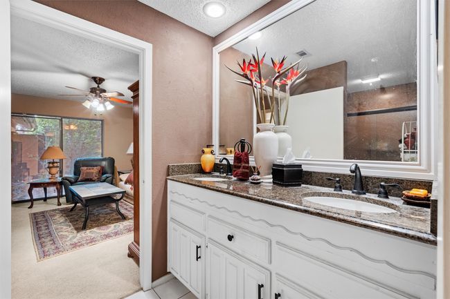 Full bath featuring a ceiling fan, a textured ceiling, double vanity, and a sink | Image 23