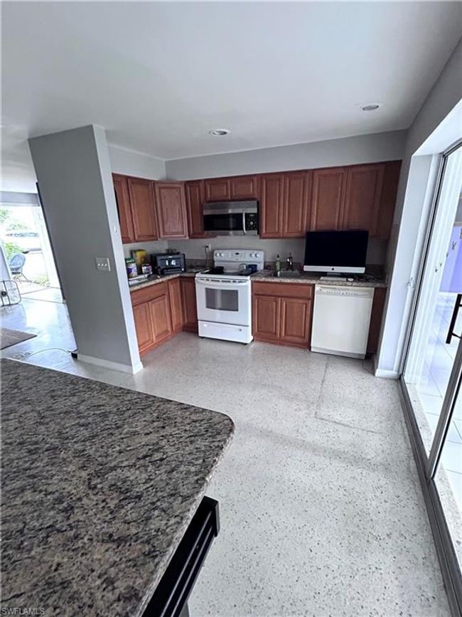 Kitchen with white range with electric stovetop and dishwasher | Image 6