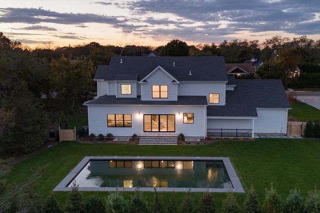 Back house at dusk featuring a yard | Image 21