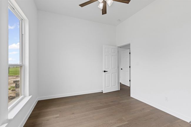 Empty room with baseboards, ceiling fan, and wood finished floors | Image 31