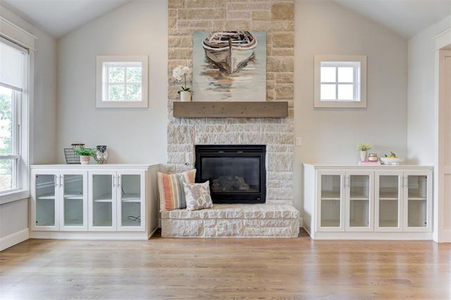 Living room with vaulted ceiling, built ins, plenty of windows with natural light and wood beams. | Image 6