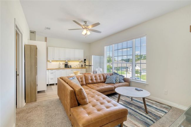 Living room featuring a ceiling fan and baseboards | Image 24