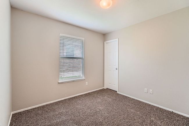 Spare room featuring carpet floors and baseboards | Image 8