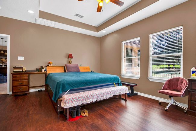 Large master bedroom with wood floors | Image 14