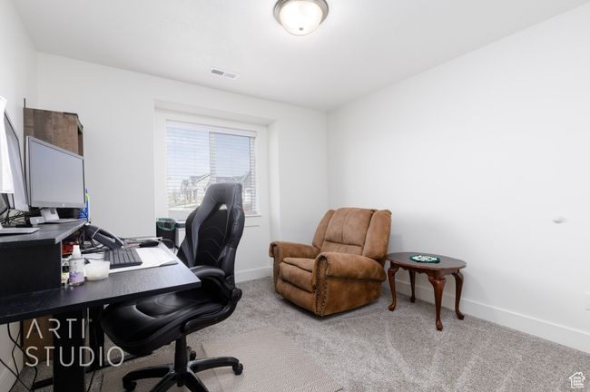 Carpeted office space featuring visible vents and baseboards | Image 21