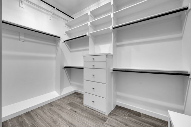 Spacious closet featuring light wood-type flooring | Image 14