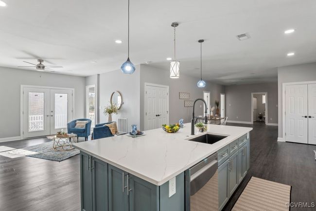 Kitchen featuring visible vents, a ceiling fan, a sink, open floor plan, and dishwasher | Image 8