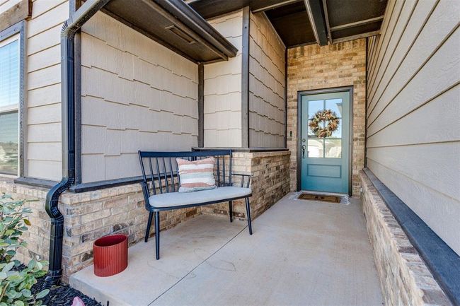 Entrance to property with a porch and brick siding | Image 4