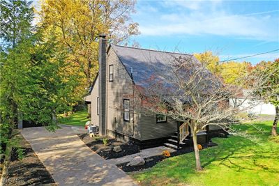 View of side of home with a yard and central air condition unit | Image 2