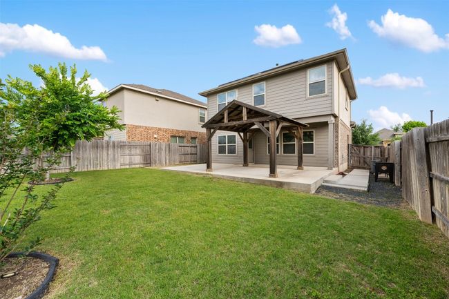 Rear view of property featuring a patio area and a gazebo | Image 33