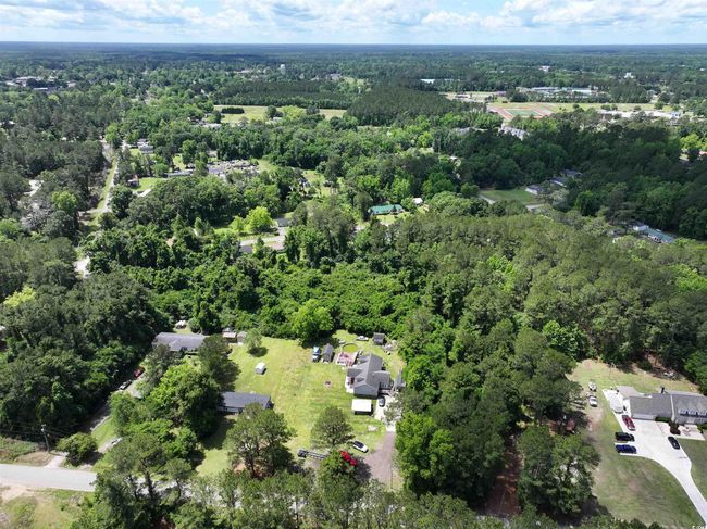 Aerial view featuring a wooded view | Image 4