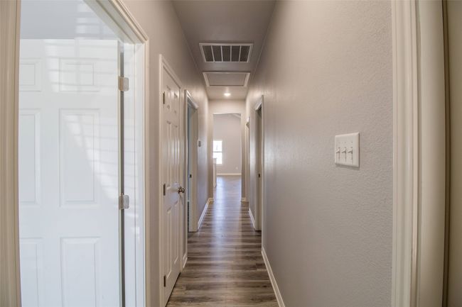 Hallway featuring dark wood-type flooring and attic access | Image 13