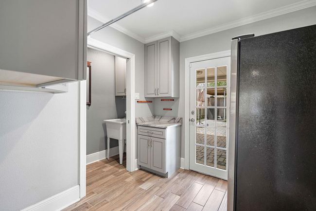 Laundry and half bath with entrance to pool area | Image 16