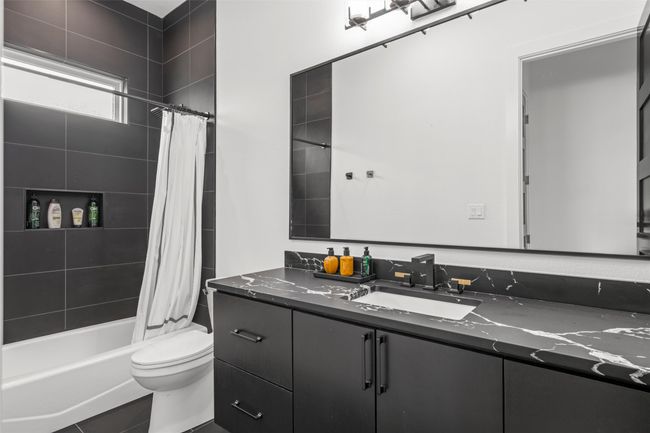 Bathroom with toilet, shower / tub combo, and vanity | Image 31
