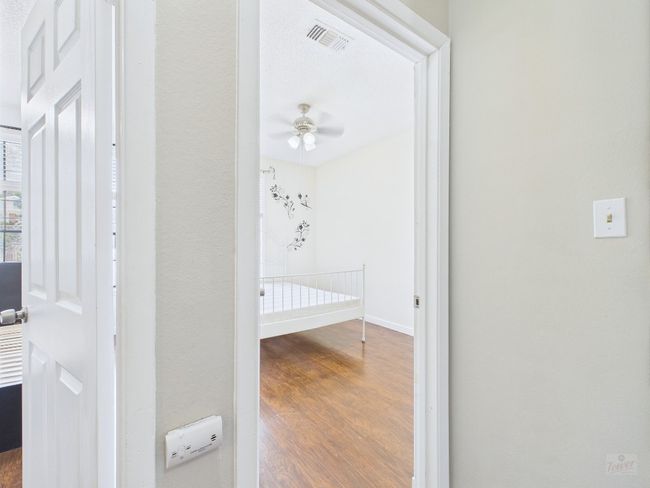 Hallway with wood finished floors and baseboards | Image 18