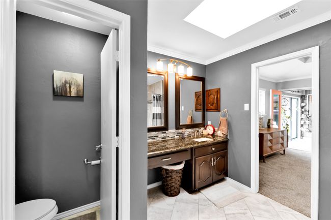 Full bathroom with vanity, ornamental molding, a skylight, and backsplash | Image 25