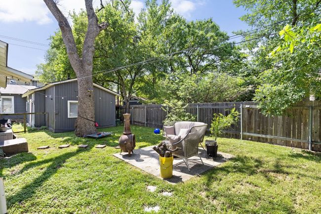 View of yard with a fenced backyard, an outdoor structure, and a patio | Image 23