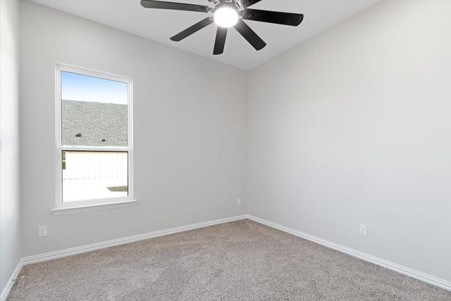 Carpeted spare room with plenty of natural light and ceiling fan | Image 11