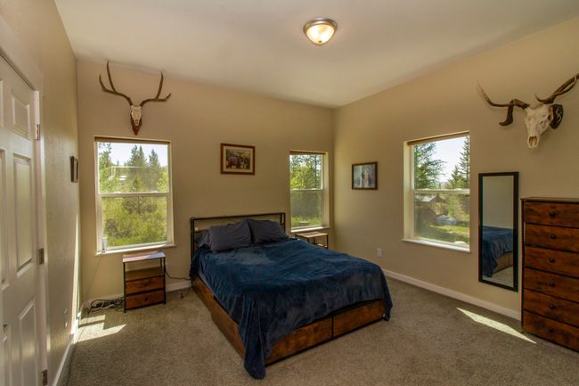 Carpeted bedroom with beautiful views from the windows | Image 7