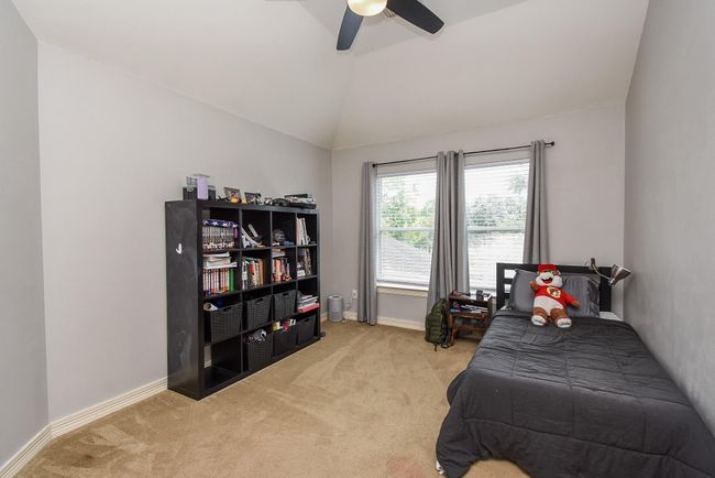 Bedroom #2 measures 11' x 13' complete with large windows, ceiling fan, cozy carpet, and spacious closet. | Image 21