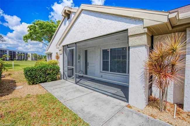 Entrance to property featuring stucco siding and a lawn | Image 8
