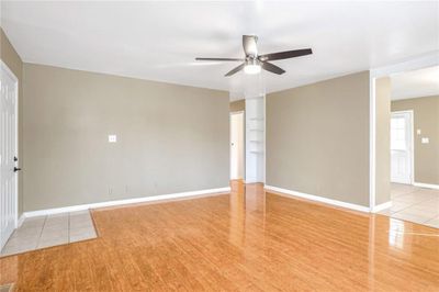 Unfurnished room featuring ceiling fan and light wood-type flooring | Image 3