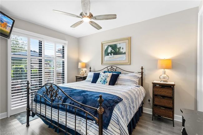 Bedroom with wood finished floors and a ceiling fan | Image 21