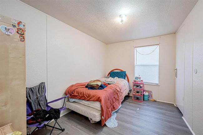 This cozy bedroom offers plenty of space for rest and relaxation | Image 12