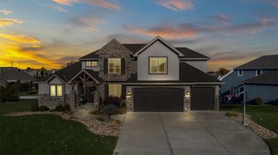 View of front of house featuring a garage and a yard | Image 2