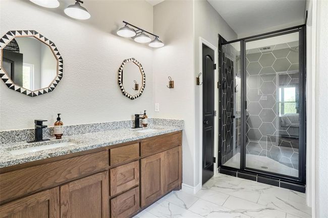 Bathroom featuring tile floors, dual bowl vanity, and an enclosed shower | Image 23