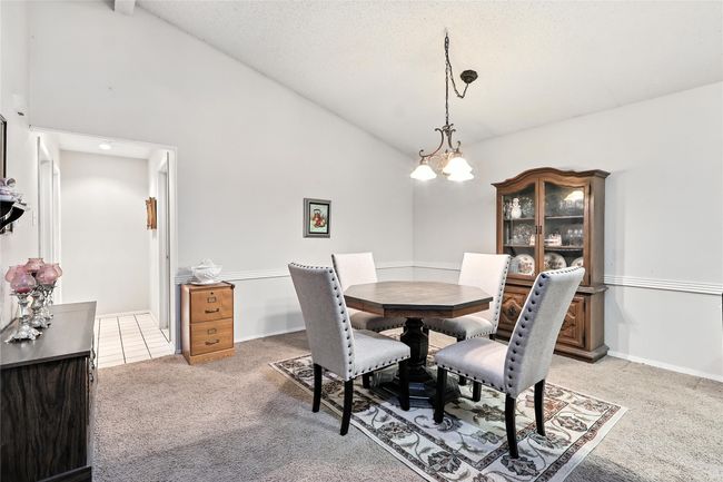 Dining space featuring light colored carpet and high vaulted ceiling | Image 20